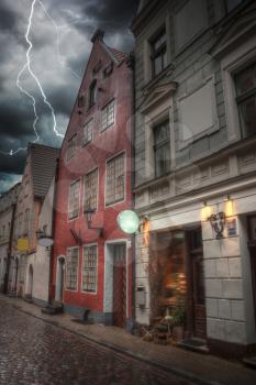 Heavy thunderstorm with lightning. old houses on Riga street. Latvia. Europe