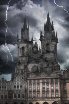 Heavy thunderstorm with lightning. Prague Old town square, Tyn Cathedral. under sunlight.