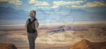 a tourist girl is traveling with a backpack in the Atacama Desert.