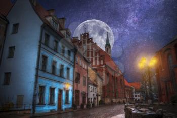 old streets of Night Riga. Lights, stars and the moon shine