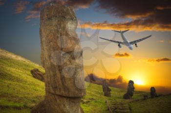 the plane is flying over Moais at Ahu Tongariki (Easter island, Chile)