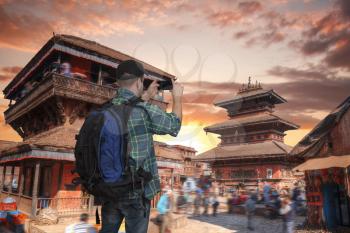 blogger tourist takes pictures on smartphone attractions, Kathmandu valey, Nepal.