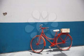 Red bicycle on a white wall background
