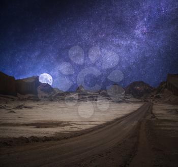 Valle de la Luna (Moon Valley) close to San Pedro de Atacama, Chiles. starry sky shines at night.