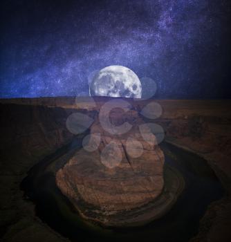 Famous Horseshoe Bend of the Colorado River in northern Arizona. night, the starry sky and the moon shine.