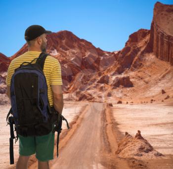 the traveler is standing with a backpack.. Moon Valley in Atacama Desert, Chile