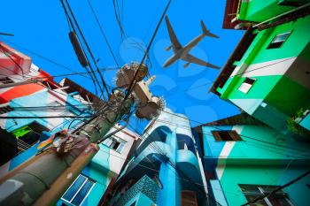 the plane flies low over the Colorful painted buildings of Favela  in Rio de Janeiro Brazil