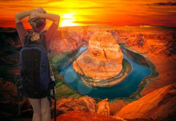 a tourist girl travels with a backpack on the Grand Canyon. USA