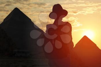 the silhouette of the woman who travels through Egypt. Against the backdrop of the pyramids of Giza.