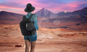female traveler looking at volcano licancabur near San Pedro de Atacama, Chile