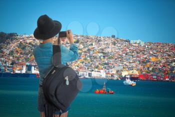 woman traveler takes pictures of the city of Valparaiso. Chile.
