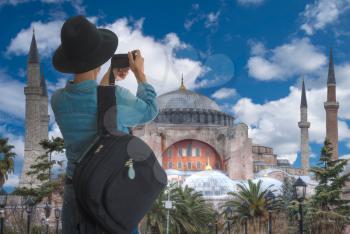 woman tourist travels through Istanbul and takes pictures on a camera