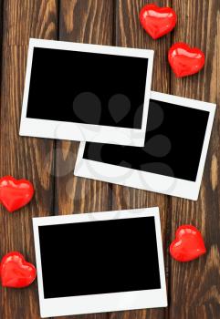 photo and red hearts on the wooden table