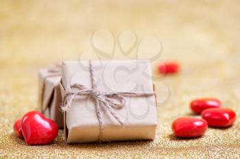 box for present and red hearts on a table