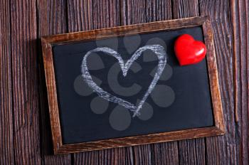 red hearts and black board on a table