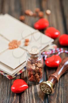 envelopes and red hearts on the wooden table