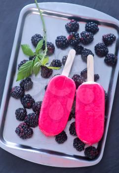ice cream with blackberry on metal tray