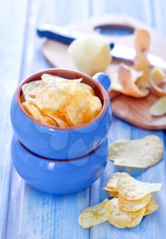 potato chips in bowl and on a table