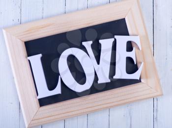 white text love on the wooden table