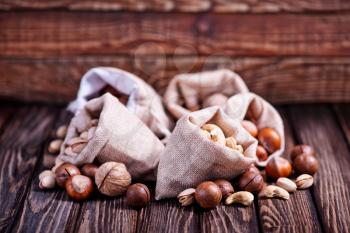 different kind of nuts on the wooden table