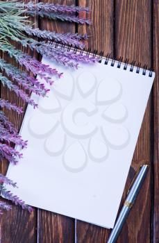 lavender and notebook on the wooden table