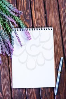 lavender and notebook on the wooden table