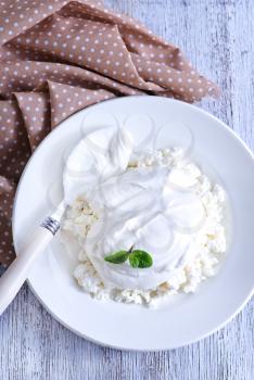 cottage with sour cream and on the plate