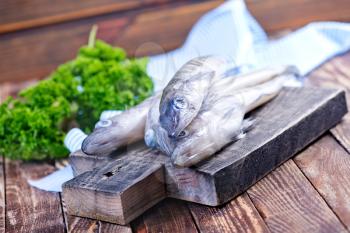 raw fish on wooden board and on a table