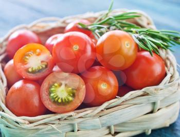 fresh tomato cherry in basket and on a table