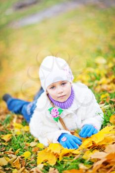 little girl in autumn forest, yellow leaves and little girl