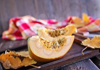 fresh yellow pumpkin on the wooden table