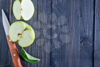 fresh apple and knife on wooden boards