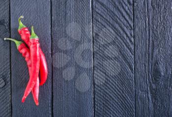chilli peppers on the wooden black boards
