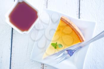 sweet cheesecake on plate and tea in cup