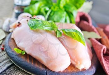 raw chicken fillet on the wooden table