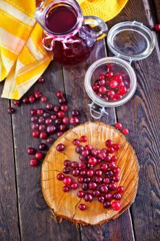 cranberry on the wooden board and on a table