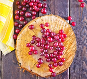 cranberry on the wooden board and on a table