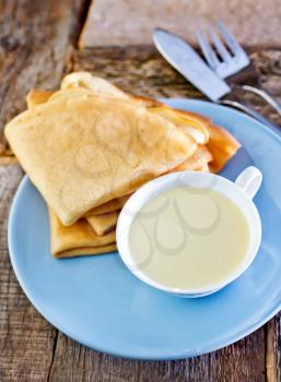 sweet pancakes with sweetened condensed milk in cup