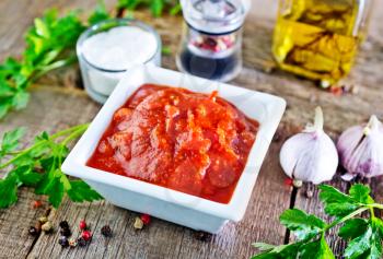 tomato sauce in white bowl and on a table