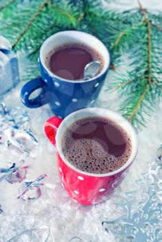 cocoa drink in red cup and on white snow