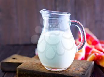fresh milk in jug and on a table