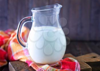 fresh milk in jug and on a table