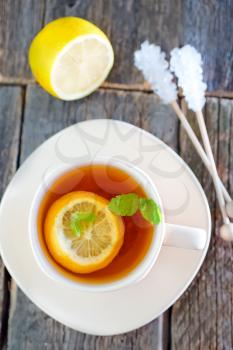 fresh tea with mint and lemon in cup