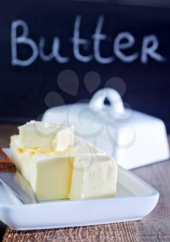 butter on white plate and on a table