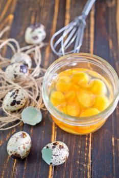raw quail eggs in bank and on a table