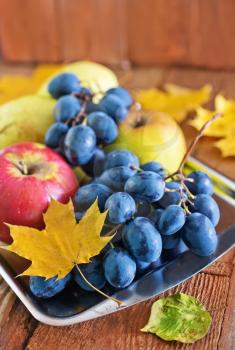 autumn harvest on the wooden background, fruits and vegetables