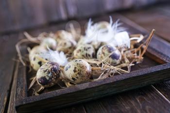 raw quail eggs on the wooden tray