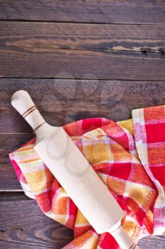wooden rolling pin and napkin on a table