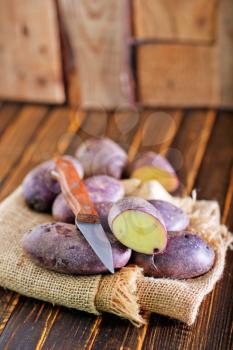raw potato, potato on the wooden table
