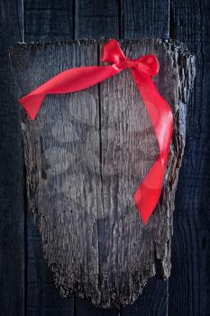 red ribbon on wooden background, festive background